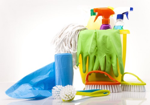 Professional using safe products during sofa cleaning service