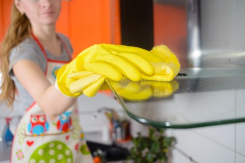 Local office cleaner working around meeting rooms and shared workspace surfaces